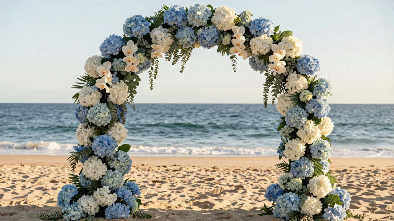 A beach wedding arch filled with hydrangeas and orchids, framed by eucalyptus in golden light.